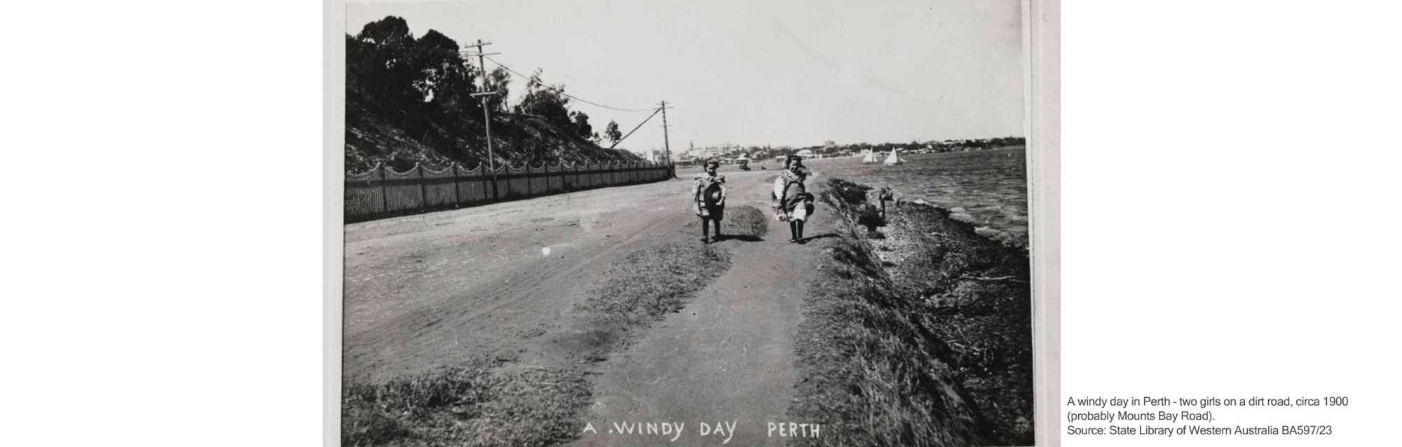 A windy day in Perth – two girls on a dirt road, circa 1900 (probably Mounts Bay Road). Source: State Library of Western Australia BA597/23